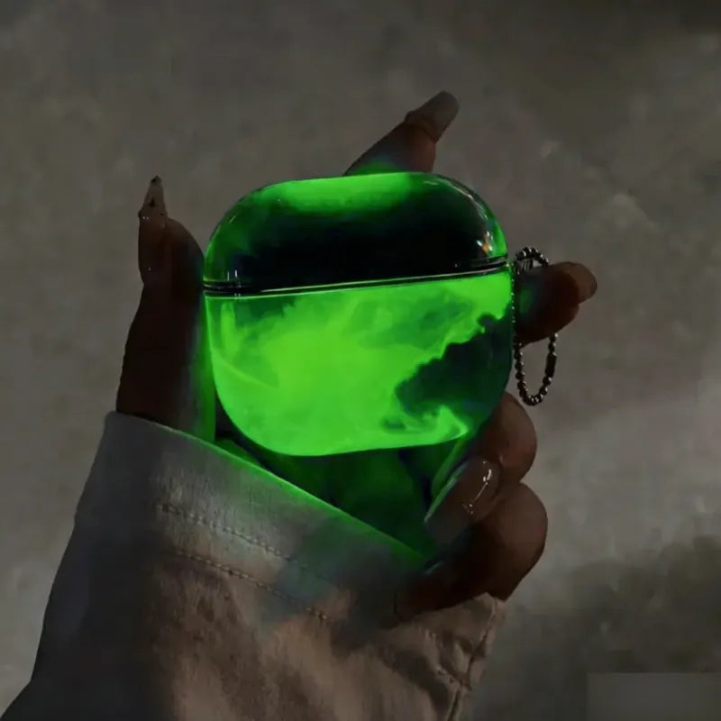 Neon Green LumiCases AirPods cover glowing vivid green in the dark, held in a hand with its keychain